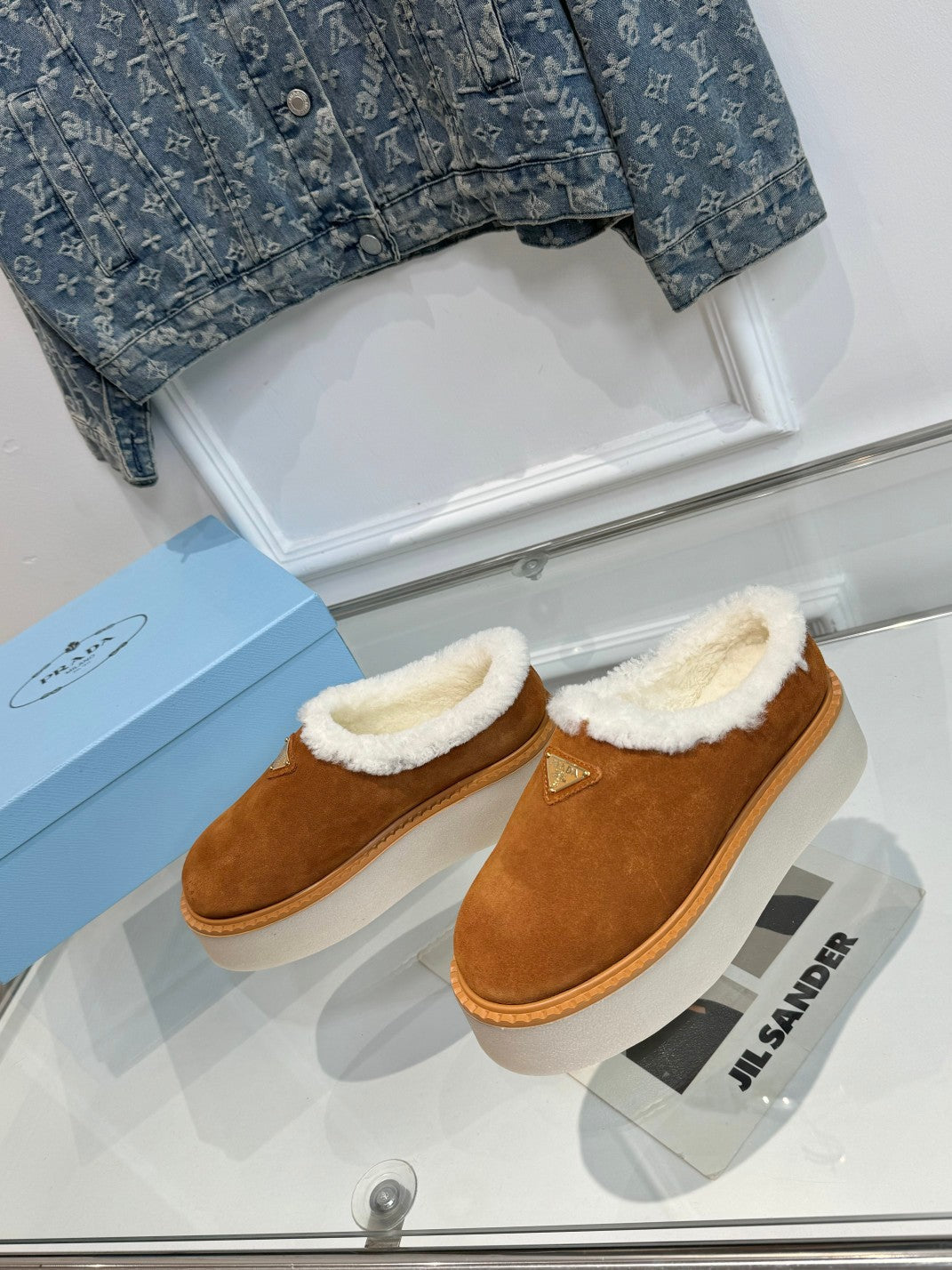 PRADA TRIANGLE LOGO MULES IN BRONZE BROWN SUEDE AND SHEARLING LINING