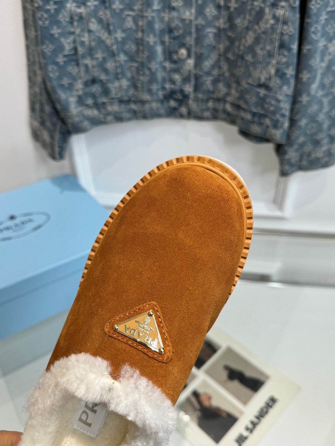 PRADA TRIANGLE LOGO MULES IN BRONZE BROWN SUEDE AND SHEARLING LINING