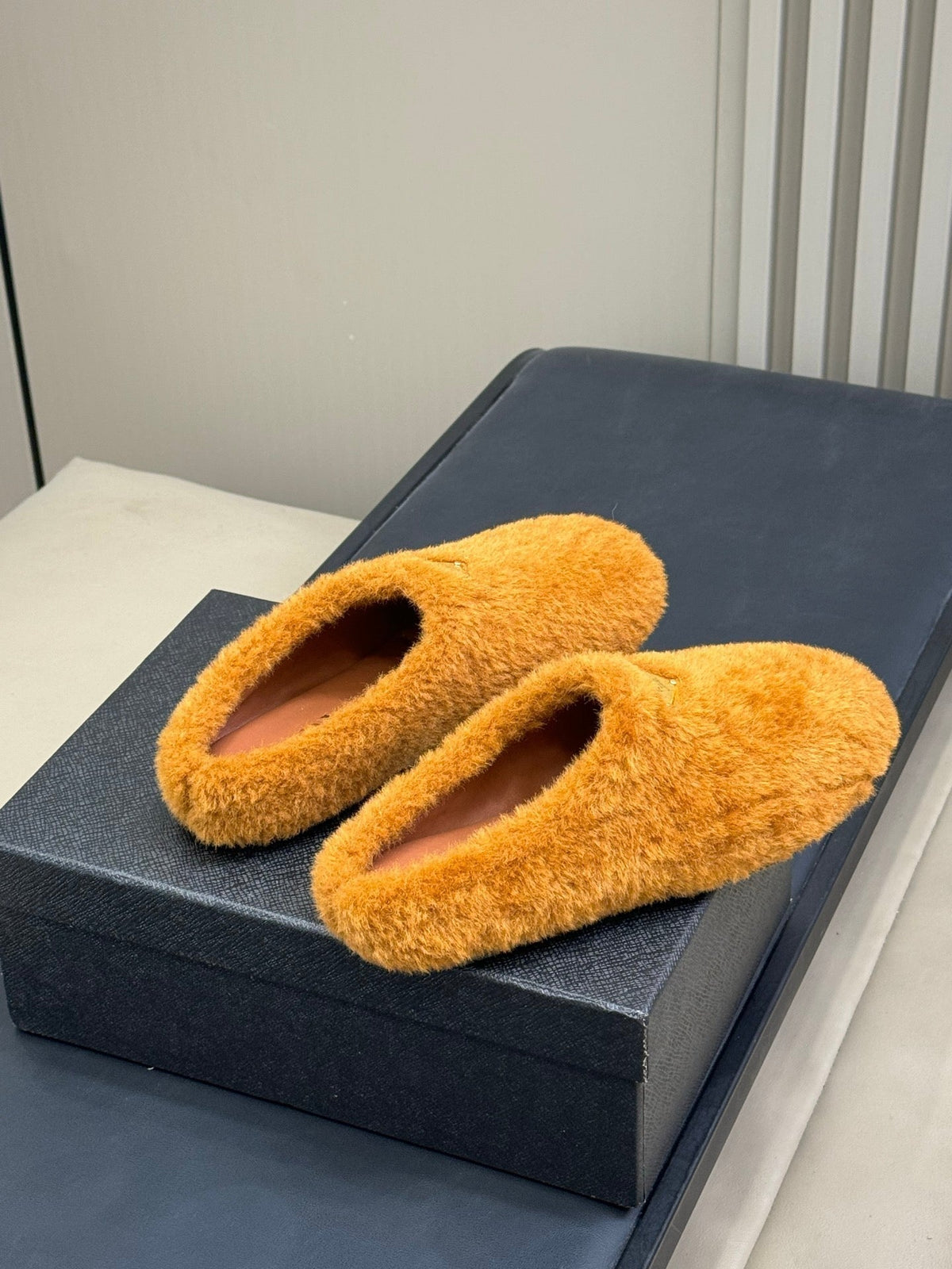 PRADA 25S CLOGS IN RK ORANGE SHEARLING