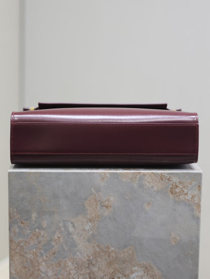 SAINT LAURENT MANHATTAN MEDIUM 29 IN WINE RED SMOOTH CALFSKIN GOLD BUCKLE